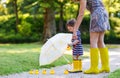Mother and little adorable daughter in yellow rubber boots, family look Royalty Free Stock Photo