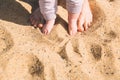 Mother and little baby feet on beach sand. Royalty Free Stock Photo