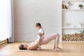 Mother with little baby girl doing abdominal exercise at home Royalty Free Stock Photo