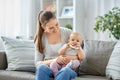 mother and little baby with teething toy at home Royalty Free Stock Photo