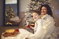 Mother and little boy son watching Christmas movie or tv Royalty Free Stock Photo