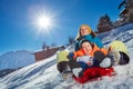 Mother with little boy together sit in the sledge go downhill Royalty Free Stock Photo