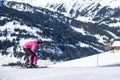 Mother and little child skiing in Alps mountains. Active mom and toddler kid with safety helmet, goggles and poles.