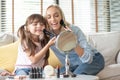 Mother and little Daughter applying cosmetic with brushes Royalty Free Stock Photo