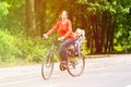 Mother and little daughter on bike in summer