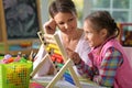 Mother with little daughter counting with abacus