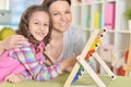 mother with little daughter counting with abacus Royalty Free Stock Photo