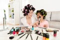 Mother with little daughter dressed hair curler