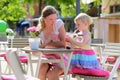 Mother and little daughter drinking in cafe Royalty Free Stock Photo