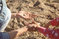 Mother and little daughter gathering shells near river Royalty Free Stock Photo