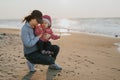 Mother and little daughter having fun on the beach. Authentic lifestyle image Royalty Free Stock Photo