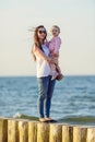 Mother and little daughter having fun on the beach. Authentic lifestyle image Royalty Free Stock Photo