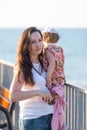 Mother and little daughter having fun on the beach. Authentic lifestyle image Royalty Free Stock Photo