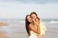 Mother and little daughter are having fun on the beach Royalty Free Stock Photo