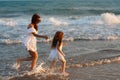 Mother and little daughter are having fun on the beach Royalty Free Stock Photo