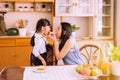 Mother and little daughter having fun with breakfast together at home kitchen in the morning,Healthy food concept Royalty Free Stock Photo