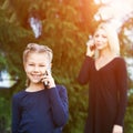 Mom and daughter. Phone conversation. Happy family portrait. Royalty Free Stock Photo