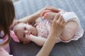 Mother and little daughter in play in the bedroom on the bed Royalty Free Stock Photo