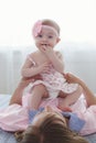 Mother and little daughter in play in the bedroom on the bed Royalty Free Stock Photo