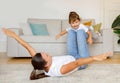 Mother and little daughter playing airplane game together at home, having fun Royalty Free Stock Photo