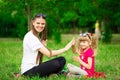 Mother and little daughter playing together in park. Outdoor Portrait of happy family. Happy Mother`s Day Joy. Royalty Free Stock Photo