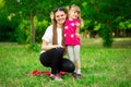 Mother and little daughter playing together in park. Outdoor Portrait of happy family. Happy Mother`s Day Joy. Royalty Free Stock Photo