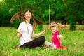 Mother and little daughter playing together in park. Outdoor Portrait of happy family. Happy Mother`s Day Joy. Royalty Free Stock Photo