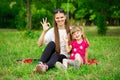 Mother and little daughter playing together in park. Outdoor Portrait of happy family. Happy Mother`s Day Joy. Royalty Free Stock Photo