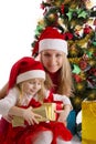 Mother and little daughter with presents under Christmas tree Royalty Free Stock Photo