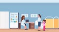 Mother with little daughter visiting pediatrician female doctor sitting workplace desk modern hospital office interior