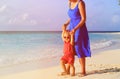 Mother and little daughter walking on tropical beach Royalty Free Stock Photo