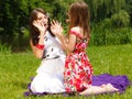 Mother and little girl blowing soap bubbles in park. Royalty Free Stock Photo