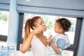 Mother and little girl brushing teeth in bathroom Royalty Free Stock Photo