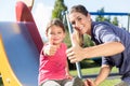 Mother and little girl chuting at adventure playground in park Royalty Free Stock Photo