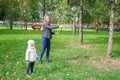 Mother and little girl daughter child blowing soap bubbles in park. Royalty Free Stock Photo