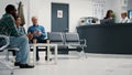 Mother with little girl leaving waiting room lobby to attend consultation Royalty Free Stock Photo