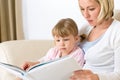 Mother with little girl read book together