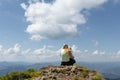 Mother and little girl standing on a cliff on top of the mountain looking down Royalty Free Stock Photo