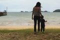 Mother and little her son is holding hand each other at the beach and looking beautiful sea Royalty Free Stock Photo