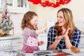 Mother and little kid girl baking gingerbread cookies for Christmas Royalty Free Stock Photo