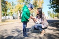 Mother and little son in an autumn park outdoors. Royalty Free Stock Photo