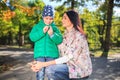 Mother and little son in an autumn park outdoors. Royalty Free Stock Photo