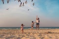 Mother with a little son and daughter are feeding seagulls on the shores of the Atlantic Ocean in Cuba, the island of Cayo Coco. Royalty Free Stock Photo