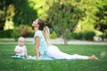 Mother and little son doing exercise outdoors. Sports concept Royalty Free Stock Photo