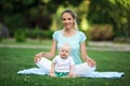 Mother and little son doing yoga exercise outdoors. Sports concept Royalty Free Stock Photo