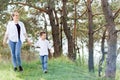 Mother and little son happy family. Attractive mom,kid boy are walking carefree outdoors summer. Parent woman goes on nature Royalty Free Stock Photo