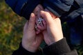 Mother and little son hold each other`s hand with a rosary