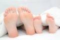 Mother and little son  laying on bed, their feets on focus Royalty Free Stock Photo