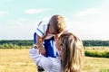 Mother and little son in the national Ukrainian dress. The mother holds the child in her arms against the background of a Royalty Free Stock Photo