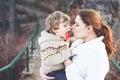 Mother and little son in park or forest, outdoors. Hugging and having fun together. Happy toddler boy and young mum, kid Royalty Free Stock Photo